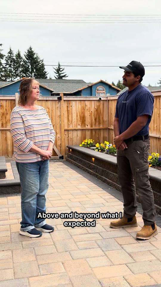 Kristen standing on her new paver patio with Darcy